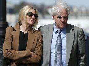 Marcia, left, and Gregory Abbott leave federal court, Wednesday, May 22, 2019, in Boston, where they pleaded guilty to charges in a nationwide college admissions bribery scandal.