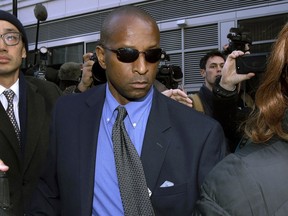 FILE - In this March 28, 2019 file photo, Rudy Meredith, former Yale women's soccer coach, departs federal court in Boston where he pleaded guilty to charges in a nationwide college admissions bribery scandal. A total of 50 people have been charged, including 33 parents, 10 coaches and college athletics officials, and seven others.