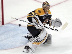 Boston Bruins goaltender Tuukka Rask, of Finland, turns the puck away during the first period in Game 1 of the NHL hockey Stanley Cup Final against the St. Louis Blues, Monday, May 27, 2019, in Boston.