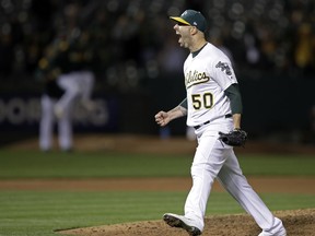 Oakland Athletics' Mike Fiers celebrates after pitching a no hitter against the Cincinnati Reds at the end of a baseball game Tuesday, May 7, 2019, in Oakland, Calif.