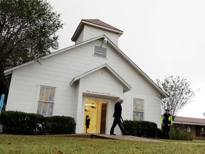 FILE - In this Nov. 12, 2017, file photo, a man walks out of the memorial for the victims of a shooting at Sutherland Springs First Baptist Church in Sutherland Springs, Texas. A South Texas church where a gunman in 2017 opened fire and killed more than two dozen congregants will unveil a new sanctuary and memorial room honoring the victims. Worshippers and relatives of those killed or injured at the First Baptist Church in Sutherland Springs are expected to gather at the newly constructed church on Sunday, May 19, 2019.