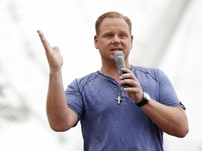 FILE - In this April 27, 2015 file photo, Nik Wallenda answers questions at a news conference in front of the Orlando Eye, in Orlando, Fla. For his next trick, daredevil Wallenda plans to cross New York's Times Square - without his feet touching the ground. ABC announced Thursday, May 23, 2019, that Wallenda and his sister Lijana will cross the tourist hotspot during a 1,300 foot simultaneous highwire walk 25 stories above the ground. ABC will air the attempt during a two-hour prime-time special on June 23.