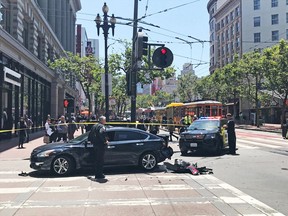 Police work at the scene where a stolen Kia SUV (not pictured) traveling at a high speed crashed into several cars, including this vehicle seen on the corner of Market Street and 5th Street in San Francisco, on Wednesday, May 29, 2019. The Kia reversed and sped off and was pursed by police vehicles. The vehicle ended up hitting a few pedestrians and several vehicles before police arrested the driver near a crash scene in the city's South of Market neighborhood, officials said.