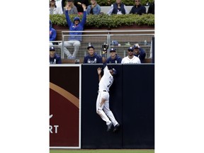 San Diego Padres center fielder Manuel Margot makes the catch over the wall for the out on New York Mets' Pete Alonso during the sixth inning of a baseball game, Wednesday, May 8, 2019, in San Diego.