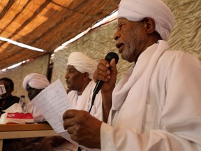 FILE - In this April 28, 2019, file, photo, Ibrahim al-Senoussi, a former aide to ousted President Omar al-Bashir, right, speaks at a press conference a day after a meeting of the Popular Congress Party, an Islamist party close to al-Bashir, was attacked by protesters, in Khartoum, Sudan. The Sudanese protesters who succeeded in driving President Omar al-Bashir from power last month say their revolution won't be complete until they have dismantled what many describe as an Islamist-dominated "deep state" that underpinned his 30-year rule. (AP Photo, File)