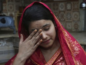 In this April 14, 2019 photo, Mahek Liaqat weeps while she recounts her ordeal in an arranged marriage to a Chinese national, in Gujranwala, Pakistan. Poor Pakistani Christian girls are being lured into marriages with Chinese men, whom they are told are Christian and wealthy only to end up trapped in China, married to men who are neither Christian nor well-to-do, and some are unable to return home.