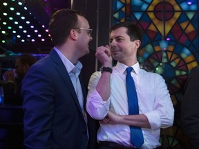 Democratic presidential candidate Pete Buttigieg, right, shares a light moment with husband, Chasten Glezman, while waiting to be introduced at a campaign event Thursday, May 9, 2019, in West Hollywood, Calif.