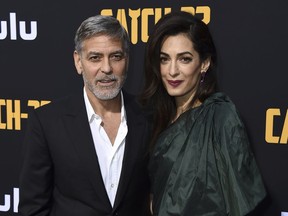 George Clooney and Amal Clooney arrive at the Los Angeles premiere of "Catch-22" at TCL Chinese Theatre on Tuesday, May 7, 2019.