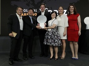 Kitkit School CEO Sooinn Lee, third from right, and Chief Engineer, Gunho Lee, second from left, receive the XPRIZE for Children's Literacy from XPRIZE Founder and Executive Chairman, Peter Diamandis, far left, Telsa CEO Elon Musk, third from left, XPRIZE CEO Anousheh Ansari, second from right, and Executive Director Emily Church, far right, Wednesday, May 15, 2019, in Los Angeles. The Berkeley-based Kitkit School and London's onebillion educational nonprofit were declared co-winners of the XPRIZE For Global Learning at a presentation Wednesday night.