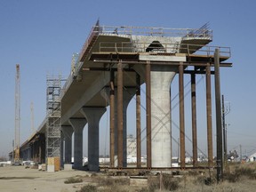 FILE - This Dec. 6, 2017, file photo shows one of the elevated sections of the high-speed rail under construction in Fresno, Calif. State rail officials issued an update to the high-speed train, Wednesday, May 1, 2019, with an estimated $18.3 billion price tag to complete 171 miles of track in the Central Valley by 2028.