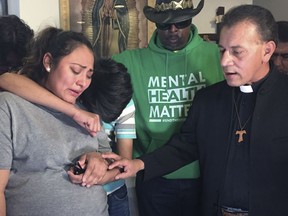 In this Tuesday, May 21, 2019 photo provided by WBEZ Radio is Adilene Marquina, left, as she sobs after announcing she will be seeking sanctuary inside Faith, Life and Hope Mission church on Chicago's Southwest Side. Hugging her is her son, Johan as Rev. Jose Landaverde, right, comforts her. A pregnant Marquina is seeking asylum in a Chicago church after she says she received a deportation order and must leave the U.S. WBEZ radio reported Tuesday that Adilene Marquina has a high-risk pregnancy and is afraid to travel back to Mexico. She is now staying at the Faith, Life and Hope Mission because U.S. immigration policy is to not make arrests in places of worship. Marquina has until Thursday to leave the U.S. Her baby is due July 23.