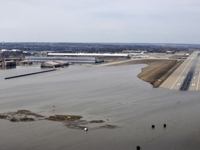 FILE - This March 17, 2019, file photo provided by the U.S. Air Force shows an aerial view of Offutt Air Force Base and the surrounding areas affected by floodwaters in Nebraska. The Air Force is raising its cost estimate to $420 million to repair and replace structures damaged at the Nebraska base following severe flooding that inundated buildings with water.