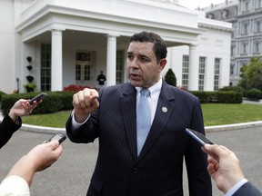 FILE - In this Sept. 13, 2017 file photo, Rep. Henry Cuellar, D-Texas, speaks with reporters outside the West Wing after a bipartisan meeting with President Donald Trump at the White House, in Washington. Kristie Small, a former senior aide to Cuellar has filed a lawsuit against the Texas Democrat in Washington D.C. on Monday that claims she was wrongly fired for being pregnant. The lawsuit argues Cuellar's firing of Small was both sex and pregnancy discrimination in violation of the Congressional Accountability Act of 1995.
