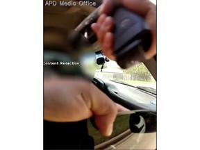 FILE - This Sept. 1, 2018, file screenshot taken from police body camera video provided by the Arlington, Texas, Police Department, shows the hand and gun of Officer Bau Tran, who came to help another officer on a traffic stop in Arlington, pointing his gun into a moving vehicle as the SUV's windows roll up and the vehicle moves forward. Tran has been charged with criminally negligent homicide for fatally shooting driver O'Shae Terry during the traffic stop. (Arlington Police Department via AP, File)