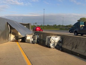 This photo released by the Indiana State Police shows a semi-trailer hauling honey overturned on a northwestern Indiana highway, spilling some of the sticky substance and restricting travel for hours in Hammond, Ind., Wednesday, May 15, 2019. State police say the truck was hauling about 41,000 pounds of amber honey along Interstate 80/94 when the driver lost control and the truck overturned. At least four containers of honey were leaking and mixing with diesel fuel from the overturned vehicle. (Indiana State Police via AP)