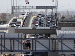 FILE - In this March 29, 2019 file photo, cars and trucks line up to enter the U.S. from Mexico at a border crossing in El Paso, Texas. A 2½-year-old Guatemalan child has died after crossing the border, becoming the fourth minor known to have died after being detained by the Border Patrol since December and raising new alarms about the treatment of migrant families seeking asylum in the United States.