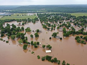 This Tuesday, May 28, 2019, aerial photo shows flooded homes along the Arkansas River in Sand Spring, Okla. Communities that have seen little rain are getting hit by historic flooding along the Arkansas River thanks to downpours upstream that have prompted officials to open dams to protect some cities but inundate others with swells of water. (DroneBase via AP)