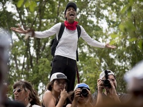 A protester shouts during a protest against the Federal Fiscal Control Board, as part of the May Day celebration, in San Juan, Puerto Rico, Wednesday, May 1, 2019. The U.S. Congress established the appointed Fiscal Control Board to oversee the debt restructuring in order to combat the Puerto Rican government-debt crisis.