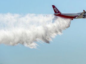 FILE - In this May 5, 2016, file photo, the Boeing 747-400 Global SuperTanker drops half a load of its 19,400-gallon capacity during a ceremony at Colorado Springs, Colo. The Global SuperTanker, the world's largest firefighting aircraft, has been readied for the 2019 wildfire season. The Boeing 747-400 series passenger jet converted for firefighting underwent maintenance recently at Pinal Airpark outside Tucson, Ariz.