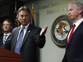 Dave Young, 17th Judicial District Attorney, front left, makes a point as George Brauchler, 18th Judicial District Attorney, front right, and U.S. Attorney Jason Dunn, back, look on during a news conference to announce that 42 people were arrested this week in one of the largest black market marijuana enforcement actions in the state's history during a news conference Friday, May 24, 2019, in Denver.