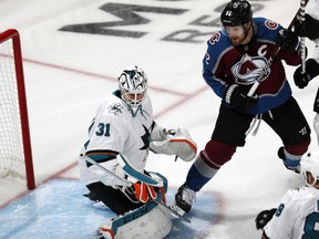 San Jose Sharks goaltender Martin Jones, left, stops a shot by Colorado Avalanche left wing Gabriel Landeskog during the first period of Game 3 of an NHL hockey second-round playoff series Tuesday, April 30, 2019, in Denver.