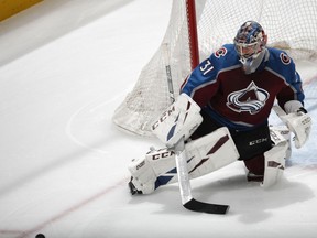 Colorado Avalanche goaltender Philipp Grubauer deflects the puck in the first period of Game 6 of an NHL hockey second-round playoff series against the San Jose Sharks, Monday, May 6, 2019, in Denver.