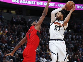 Portland Trail Blazers forward Maurice Harkless, left, reaches up to block a shot by Denver Nuggets guard Jamal Murray during the first half of Game 2 of an NBA basketball second-round playoff series Wednesday, May 1, 2019, in Denver.