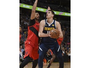 Denver Nuggets center Nikola Jokic, right, goes up for a basket Portland Trail Blazers center Enes Kanter, left, in the first half of Game 7 of an NBA basketball second-round playoff series Sunday, May 12, 2019, in Denver.