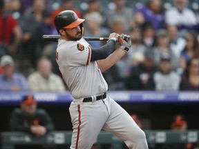 Baltimore Orioles' Trey Mancini follows through with his swing after connecting for a double against the Colorado Rockies in the first inning of a baseball game Friday, May 24, 2019, in Denver.