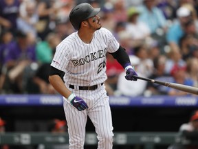 Colorado Rockies' Nolan Arenado follows the flight of his two-run home run off Baltimore Orioles starting pitcher David Hess in the sixth inning of a baseball game Sunday, May 26, 2019, in Denver.