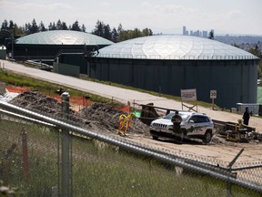 A court will rule today if a proposed British Columbia law that restricts diluted-bitumen shipments through its borders is constitutional. A security guard stands nearby construction workers at the Kinder Morgan Burnaby Terminal tank farm, the terminus point of the Trans Mountain pipeline, in Burnaby, B.C., on Tuesday, April 30, 2019.