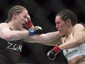 Alexis Davis, from Canada, right, trades blows with Sarah Kaufman, from Canada, during their UFC 186 bantamweight fight in Montreal, Saturday, April 25, 2015. With titles in Strikeforce and Invicta, UFC veteran Sarah Kaufman is a trailblazer for Canadian mixed martial arts.