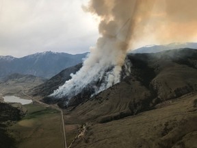 A wildfire burns near Osoyoos, B.C. in this undated handout photo. A growing wildfire in British Columbia's southern Okanagan region has prompted additional evacuation alerts for several properties west of the town of Osoyoos. Residents of 13 properties along Sumac Road and Highway 3 in Cawston are being warned to be ready to leave on short notice as a wildfire sparked Monday by a burning vehicle has now scorched four square kilometres of bush.