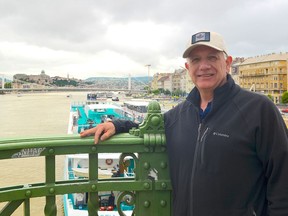 Ken Hoffer, of Halifax, poses on the Liberty Bridge above the Danube River in Budapest, Hungary, on Thursday, May 30, 2019. A Canadian tourist who was on the Danube River in Budapest when two boats collided Wednesday says the experience was "surreal and "sobering". Ken Hoffer, of Halifax, says he was on a cruise boat about two bridges down from where the crash occurred, when he saw a man in a life ring float by in the chilly and fast moving water.