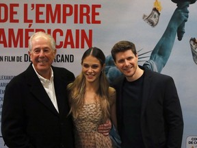 Canadian director Denys Arcand, left, actor Alexandre Landry, center, and actress Maripier Morin pose during a photocall for the French premiere of the film 'The Fall of the American Empire' in Paris, on February 12, 2019. Quebec filmmaker Denys Arcand believes that centuries from now, people will remember our current political moment as the end of an era. In this way, the title of his latest feature, "The Fall of the American Empire," could also be read as "these times we are living in," Arcand said.