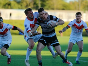 Blake Wallace of the Toronto Wolfpack is tackled by a Sheffield Eagle in a Betfred Championship rugby league game Friday at Olympic Legacy Park in Sheffield, England on Friday, May 24, 2019.