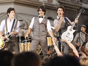 This Sept. 7, 2008 file photo shows The Jonas Brothers, from left, Nick Jonas, Joe Jonas and Kevin Jonas performing at the 2008 MTV Video Music Awards in Los Angeles. The Jonas Brothers have announced a new 40-city tour that includes two Canadian dates.