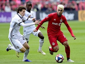 Philadelphia Union midfielder Brenden Aaronson (22) and teammate Jamiro Monteiro (35) pressure Toronto FC midfielder Alejandro Pozuelo (10) during second half MLS soccer action in Toronto on Saturday, May 11, 2019. While Toronto will be without the suspended Pozuelo for Sunday's visit by the San Jose Earthquakes, coach Greg Vanney says a week off for the Spanish playmaker may not be such a bad thing given his prolonged season since coming over from Europe.