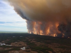 The Chuckegg Creek wildfire burns in the High Level Forest Area, to the southwest and west of the town of High Level, Alta. in this photo posted on the Alberta Wildfire Twitter page on Saturday, May 18, 2019. Fire officials say the winds continue to be favourable as crews battle a large wildfire burning a few kilometres from a northwestern Alberta town.Nearly 5,000 people have cleared out of High Level and nearby First Nations with flames licking at the southern edge of the community, which is about 750 kilometres northwest of Edmonton.