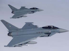 German Eurofighter Typhoon fighter jets participate in NATO's Baltic Air Policing Mission operate in Lithuanian airspace during an air force exercise on April 25, 2017. Canada's top military procurement official says the U.S. will have to ultimately sign off on whatever fighter jet this country purchases, but that he is not concerned about political interference. Patrick Finn, the Defence Department's assistant deputy minister of materiel, says the U.S. will need to certify whatever fighter jet Canada to ensure it meets American security standards. That is because whatever aircraft replaces Canada's aging CF-18s will need to be able to tap into the U.S.'s most secure intelligence network to help protect North America through Norad. Industry sources have quietly worried that could provide a pretext for the U.S. to block Canada from purchasing either the Eurofighter Typhoon or the Saab Gripen, both of which are made by European companies.