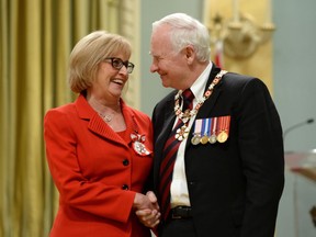 Governor General David Johnston invests Janice MacKinnon of Saskatoon, Sask., into the Order of Canada during a ceremony at Rideau Hall in Ottawa on Wednesday, May 7, 2014. Former Saskatchewan finance minister Janice MacKinnon is heading a panel of experts looking into Alberta's finances.