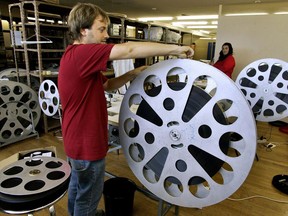 A worker prepares a movie reel at the 53rd San Sebastian Film Festival Cinema in San Sebastian nothern Spain, Wednesday, Sept. 15, 2005. Women are making some headway towards gender parity in Canadian film and TV production, but a new report says progress isn't being shared across the board.