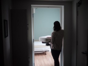 A staff member carries bedding in one of the suites at Toronto's Interval House, an emergency shelter for women in abusive situations, on Monday February 6, 2017. Newly compiled data shows an alarmingly high number of women who are victims of violence are being turned away from shelters across Canada due to a chronic lack of resources and funding for women's shelters.