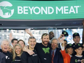 Ethan Brown, center, CEO of Beyond Meat, attends the Opening Bell ceremony with guests to celebrate the company's IPO at Nasdaq, Thursday, May 2, 2019 in New York. Cattle producers across the country are backing Quebec colleagues who have filed a complaint over a popular new meatless burger that is being advertised as "plant-based meat." The Quebec Cattle Producers Federation says the marketing that goes with Beyond Meat's vegan products is misleading and goes against Canadian rules and they're calling on the country's food inspection agency to intervene.THE CANADIAN PRESS/AP/Mark Lennihan
