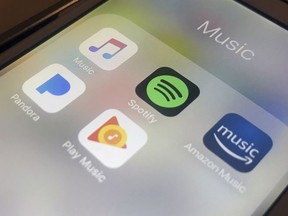 This Sunday, Jan. 28, 2018, photo shows music streaming apps clockwise from top left, Apple, Spotify, Amazon, Pandora and Google on an iPhone in New York. An all-party committee of MPs is recommending the goverment set stricter rules for Canadian content on foreign streaming services and a crack down on internet piracy.THE CANADIAN PRESS/AP/Jenny Kane