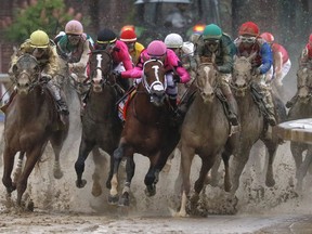 Luis Saez riding Maximum Security, second from right, goes around turn four with Flavien Prat riding Country House, left, Tyler Gaffalione riding War of Will and John Velazquez riding Code of Honor, right, during the 145th running of the Kentucky Derby horse race at Churchill Downs Saturday, May 4, 2019, in Louisville, Ky. A fight over which horse won a Canadian Derby race in Edmonton two years ago is set to be heard in court this week.