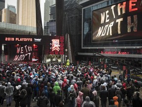NBA basketball fans brave the rain to cheer on the Toronto Raptors as they play the Philadelphia 76ers during first half NBA Eastern Conference semifinal action in Toronto on Sunday, May 12, 2019.