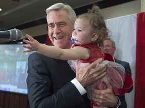 Premier Dwight Ball holds his granddaughter Antonia Ball-Barry in Corner Brook, Newfoundland and Labrador after winning the provincial election on Thursday, May 16, 2019.