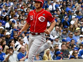 Cincinnati Reds' Nick Senzel (15) scores during the first inning of a baseball game against the Chicago Cubs Sunday, May 26, 2019, in Chicago.