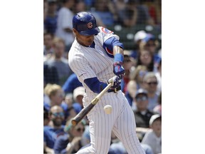 Chicago Cubs' Addison Russell hits a two-run home run during the fourth inning of a baseball game against the Cincinnati Reds, Saturday, May 25, 2019, in Chicago.